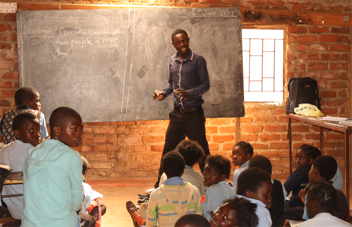 Teacher leading class at a Zambian community school