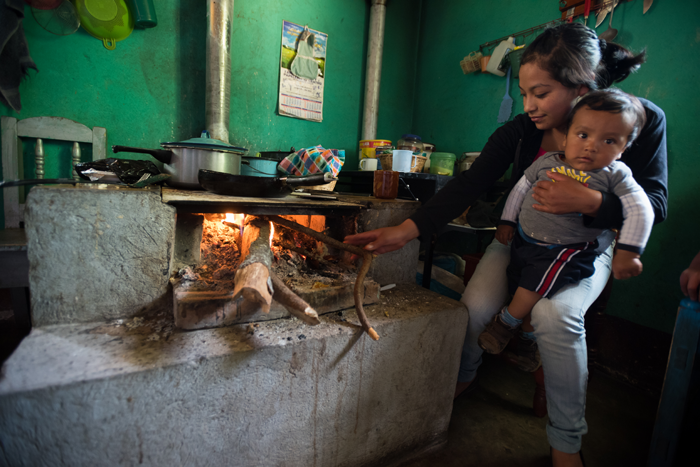 Mother and child cooking fish in Guatemala