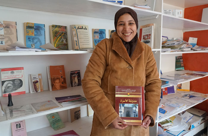 Khadija holding one of the books she shares with her students in Morocco