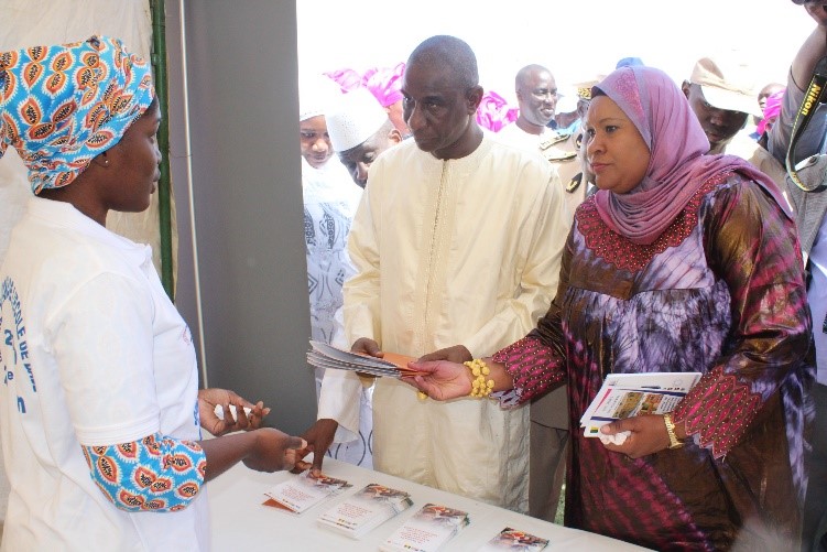 The Senegalese Minister of Education (light yellow robe) and the Director of Elementary Education (with a headscarf) talking with Odia Cisse, Counterpart Senegal’s Program Manager at the exhibition booth