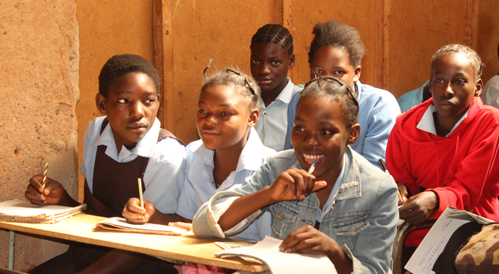 Students sitting at new desks in Zambian community school