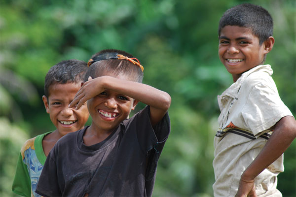 Children from a rural Suco (village) smile for the camera in Timor Leste